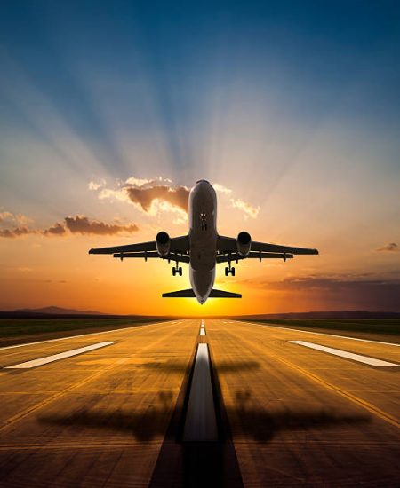 Passenger jet airplane taking off at sunset Passenger jet airplane taking off at sunset